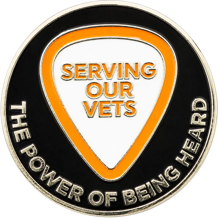 Back of the coin: The Power of Being Heard around a white guitar pick reading Serving Our Vets